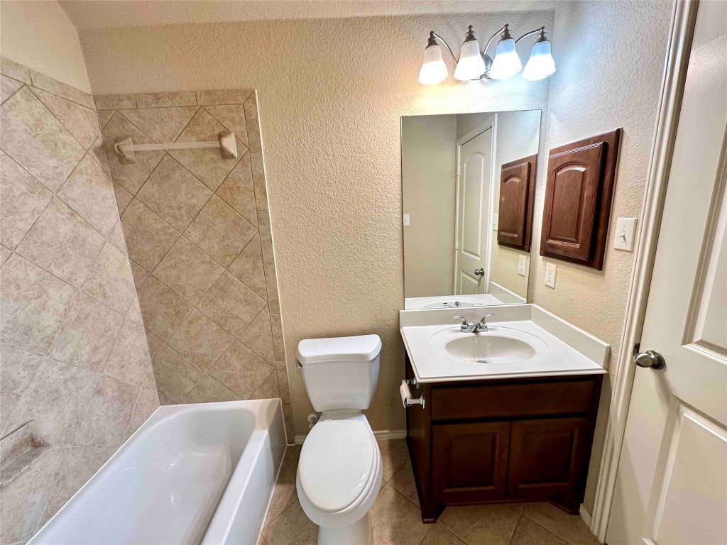 1801 Tall Chief Leander, TX 78641 - Photo 4 of 23 a bathroom with a toilet sink and mirror