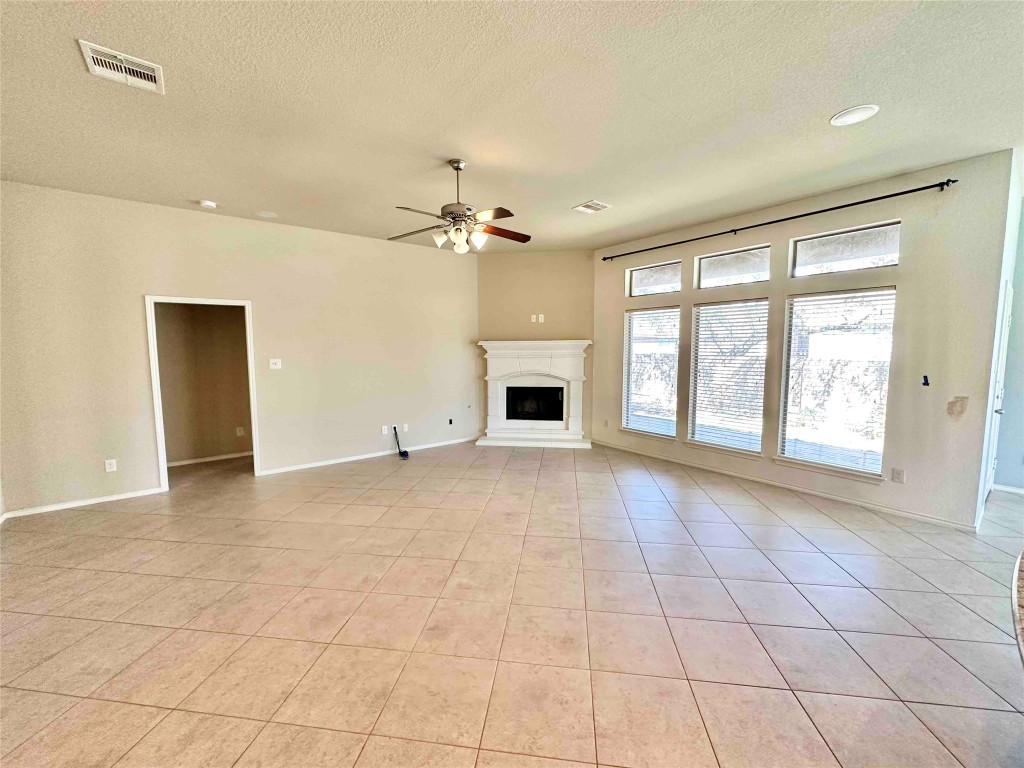 1801 Tall Chief Leander, TX 78641 - Photo 9 of 23 a view of an empty room with a fireplace and a window
