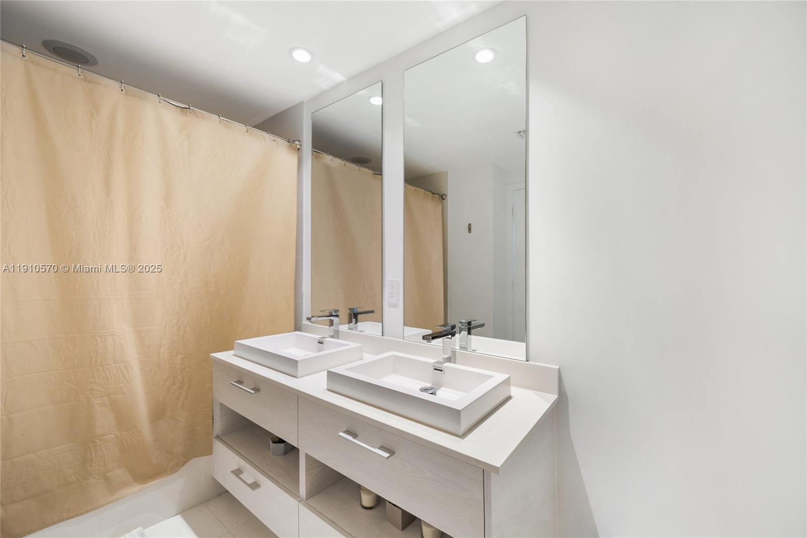 45 Southwest 9th Street, Unit 1904 Miami, FL 33130 - Photo 6 of 15 a bathroom with a sink and a mirror