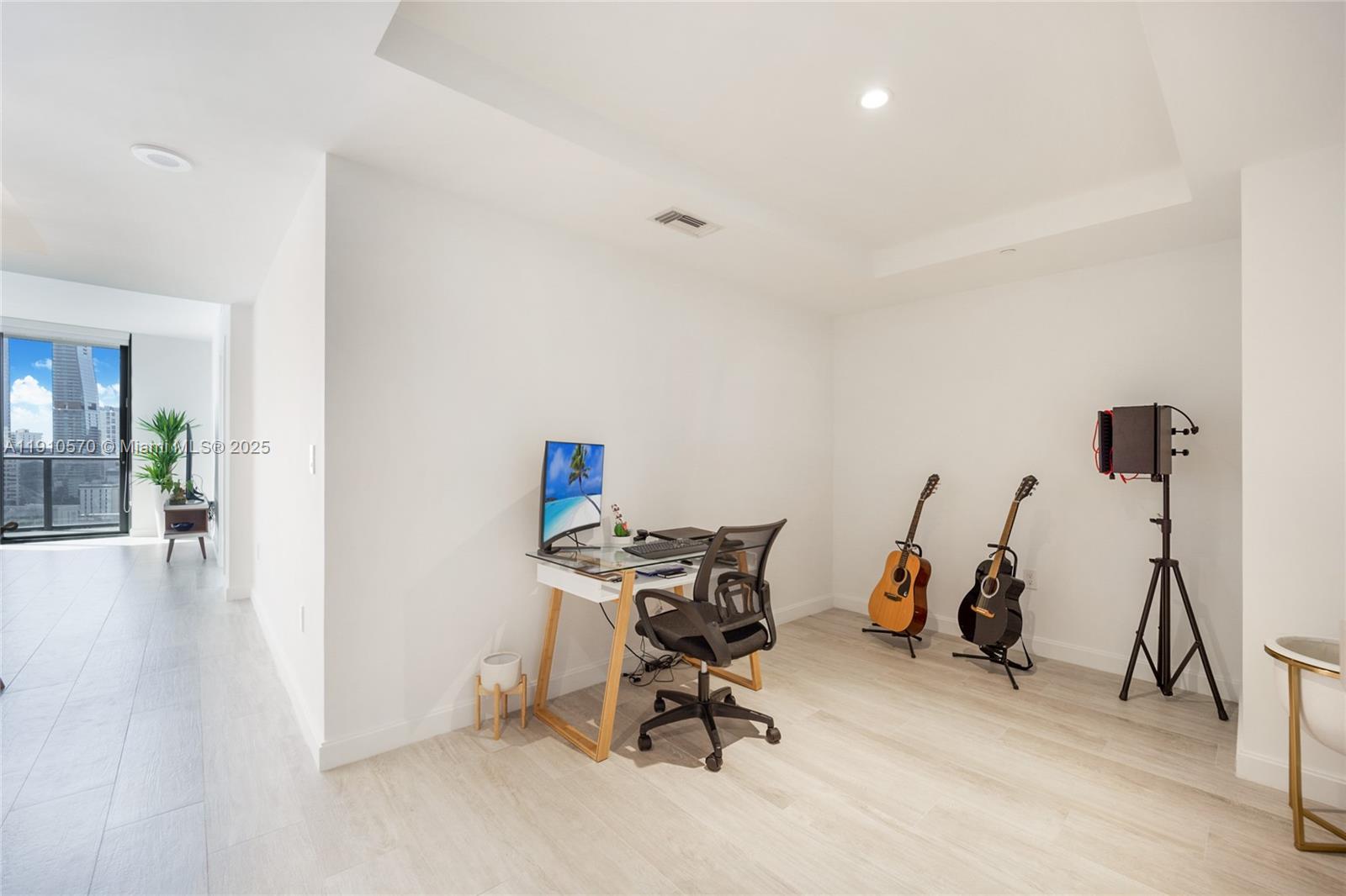 45 Southwest 9th Street, Unit 1904 Miami, FL 33130 - Photo 7 of 15 a view of a workspace with furniture and gym equipment