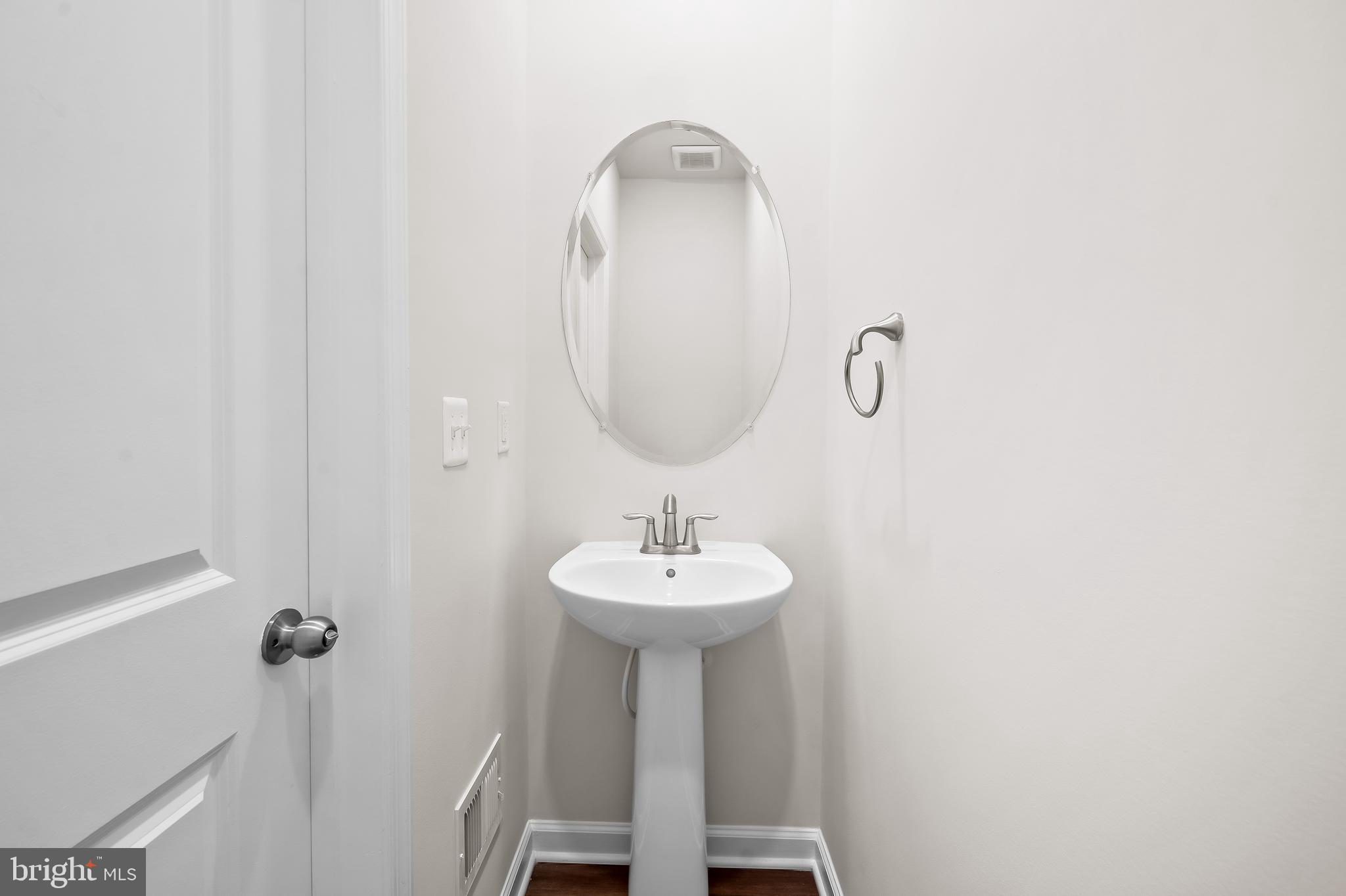 657 Mozart Way Baltimore, MD 21224 - Photo 9 of 39 a bathroom with a sink a mirror and tub
