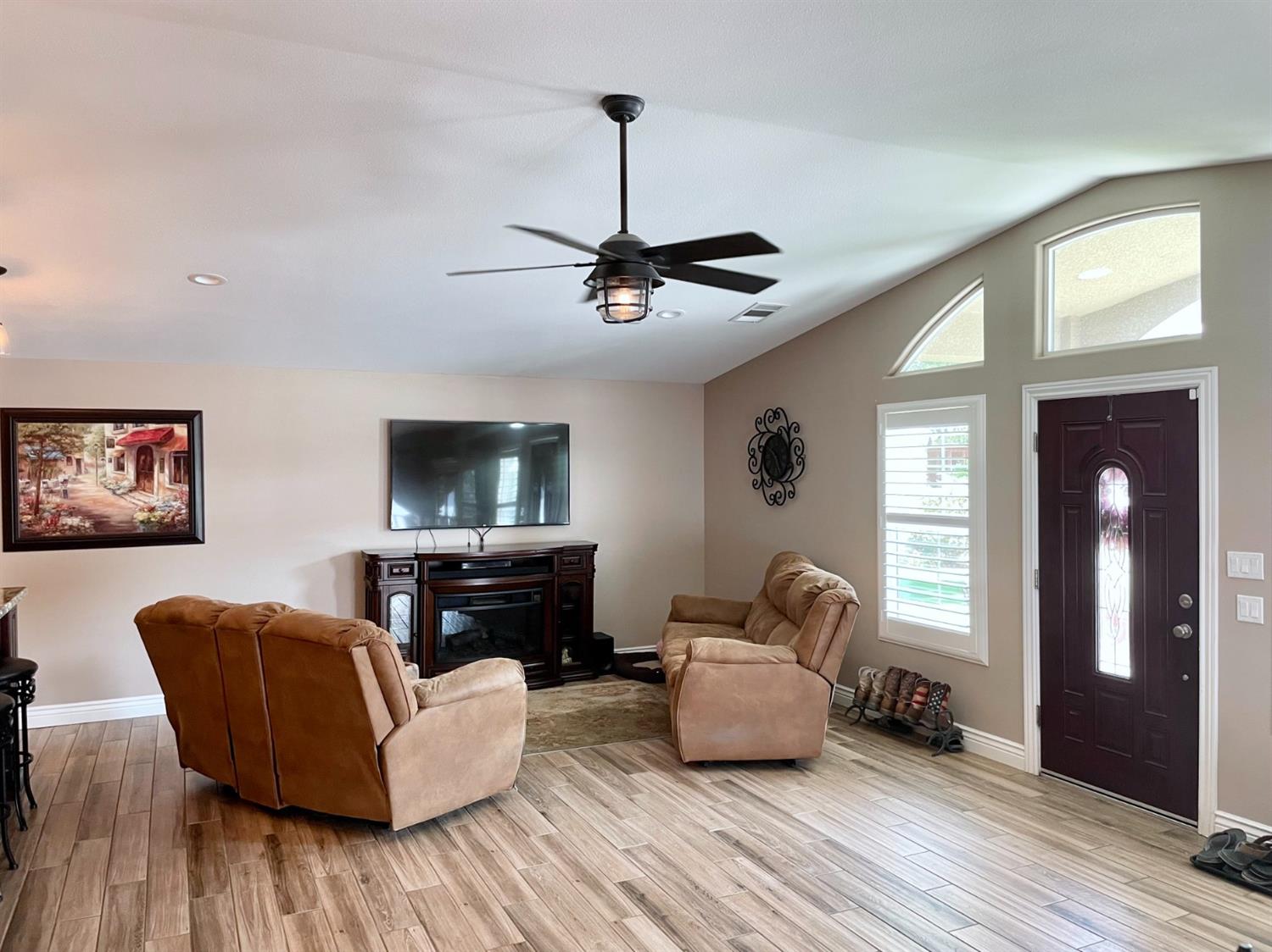 16760 West Hanford Armona Road Lemoore, CA 93245 - Photo 17 of 36 a living room with furniture and a flat screen tv