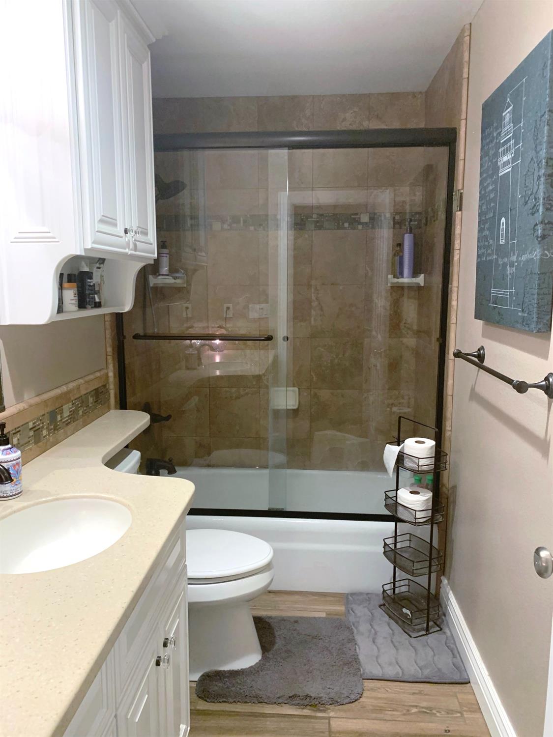 16760 West Hanford Armona Road Lemoore, CA 93245 - Photo 21 of 36 a bathroom with a sink toilet and shower