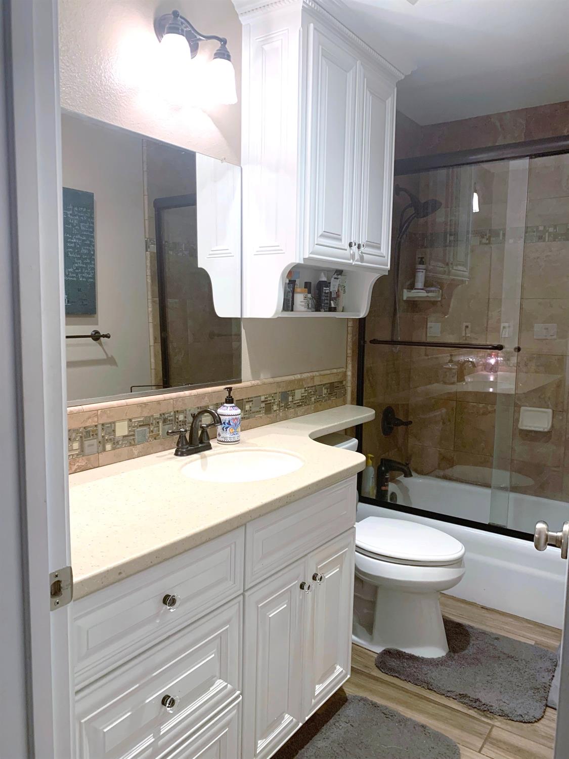 16760 West Hanford Armona Road Lemoore, CA 93245 - Photo 22 of 36 a bathroom with a sink a toilet and shower