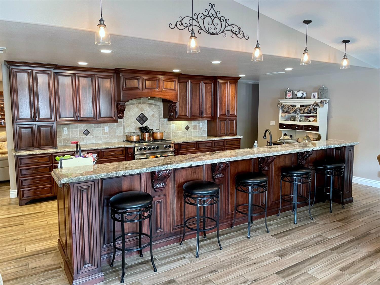 16760 West Hanford Armona Road Lemoore, CA 93245 - Photo 8 of 36 a kitchen with stainless steel appliances granite countertop a table chairs sink and cabinets