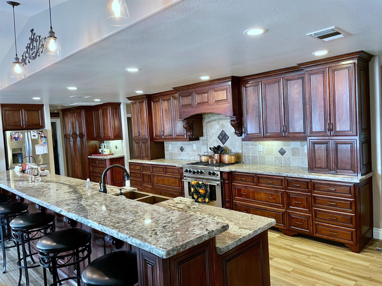 16760 West Hanford Armona Road Lemoore, CA 93245 - Photo 10 of 36 a kitchen with stainless steel appliances granite countertop wooden cabinets a stove and center island