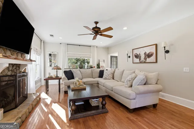 a living room with furniture fireplace and a flat screen tv