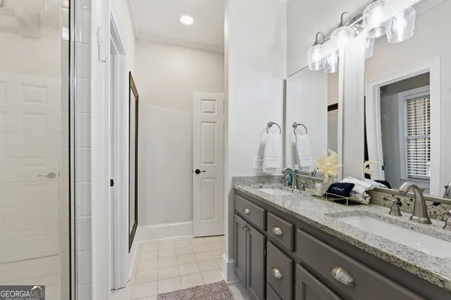 a bathroom with double vanity sinks and a mirror