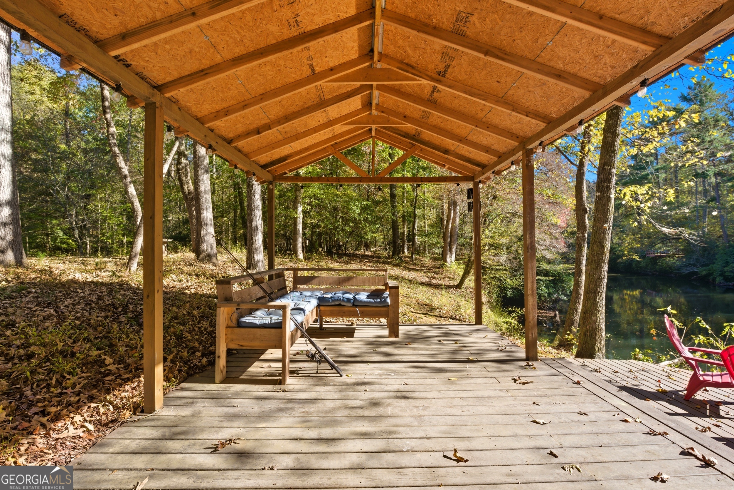 478 Chattahoochee Glen Road Clarkesville, GA 30523 - Photo 43 of 58 a view of a patio with a table and chairs under an umbrella
