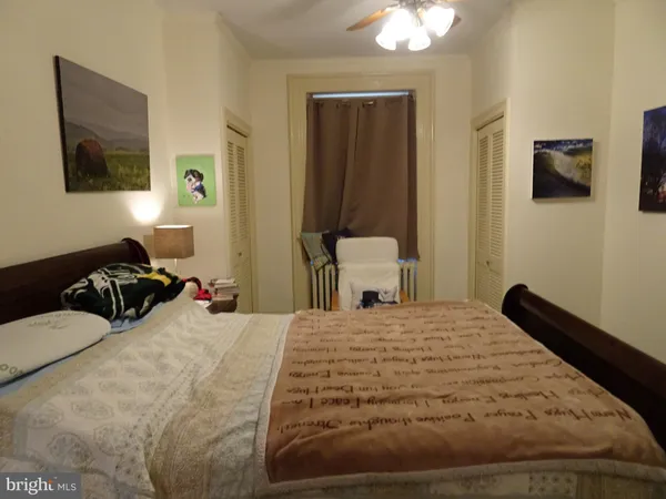 a bedroom with a bed and a tv