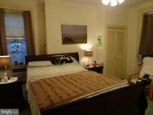 a bedroom with a bed and a dresser