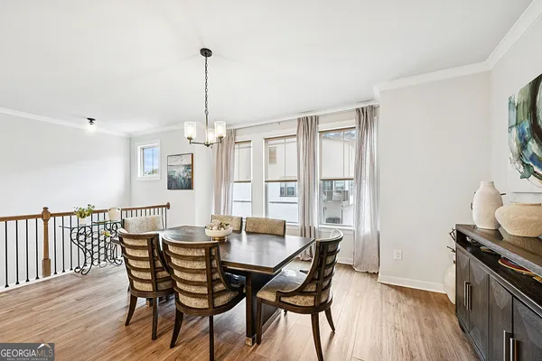 a kitchen with stainless steel appliances kitchen island granite countertop a dining table chairs and stove top oven