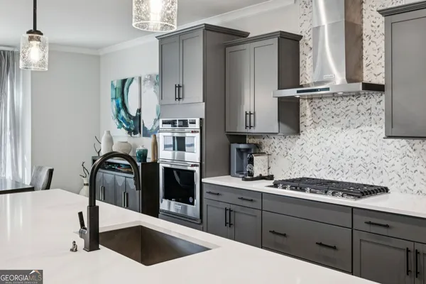 a kitchen with stainless steel appliances kitchen island sink refrigerator and stove