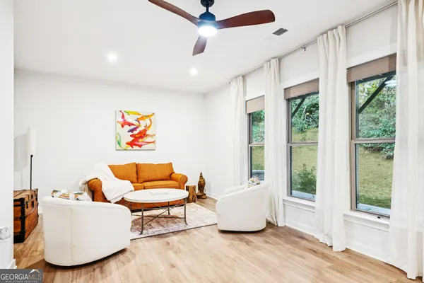 a living room with furniture and a large window