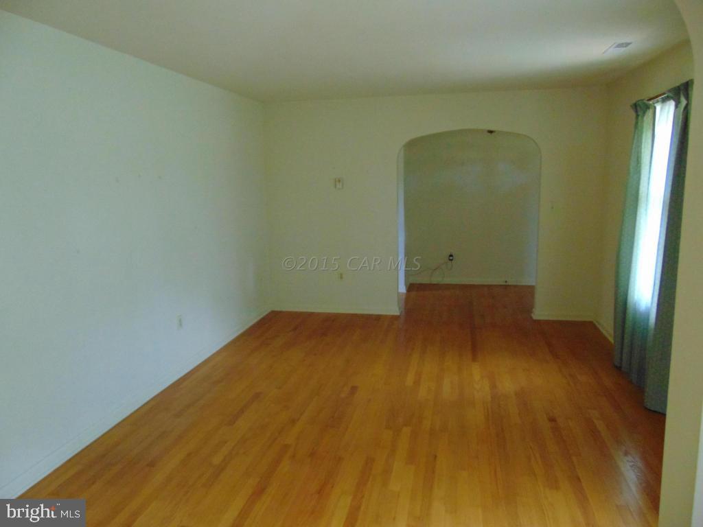 32848 Perryhawkin Road Princess Anne, MD 21853 - Photo 8 of 48 an empty room with wooden floor and windows