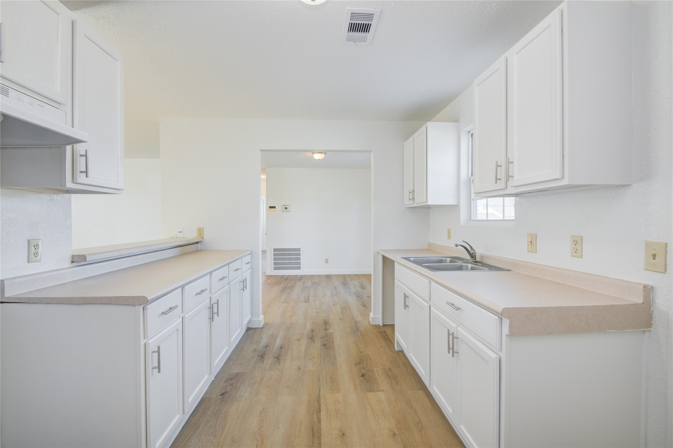 424 South Avenue B Freeport, TX 77541 - Photo 14 of 33 a kitchen with a sink stove and cabinets