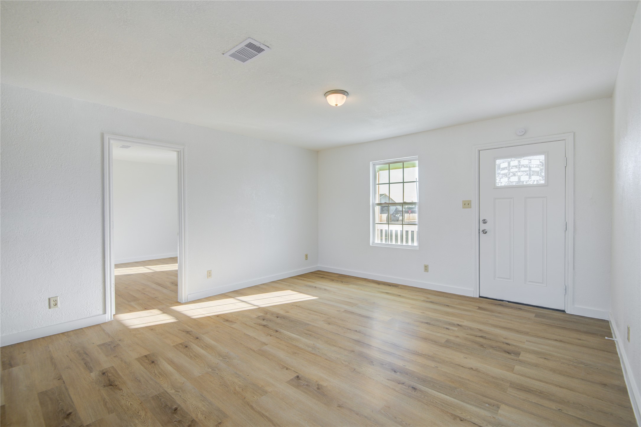 424 South Avenue B Freeport, TX 77541 - Photo 9 of 33 an empty room with wooden floor and windows