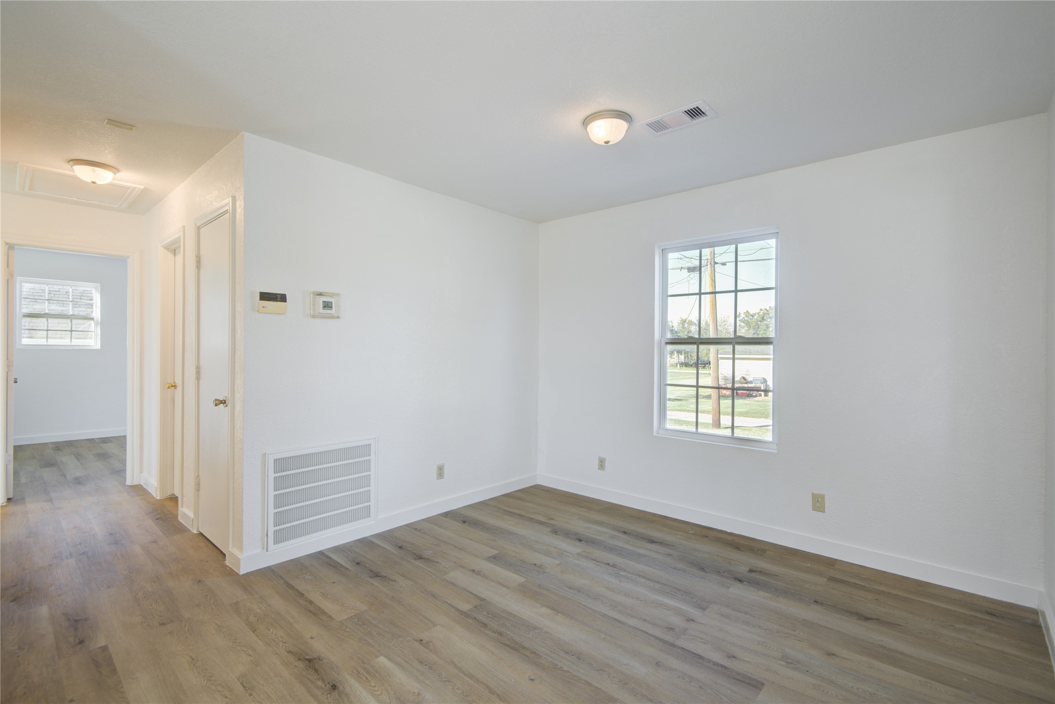 424 South Avenue B Freeport, TX 77541 - Photo 10 of 33 a view of an empty room with wooden floor and a window