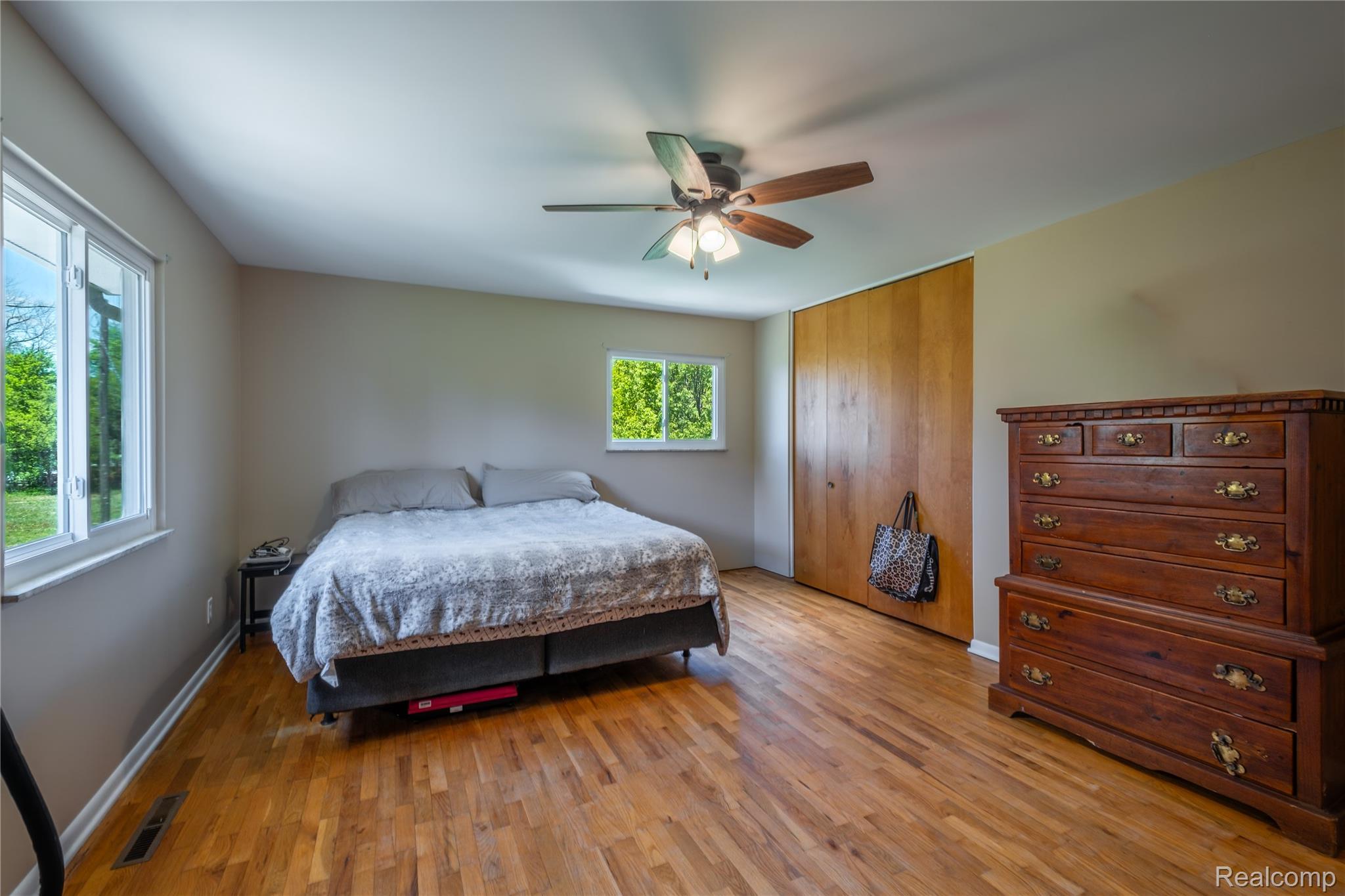 4240 Sheridan Road Flushing, MI 48433 - Photo 19 of 44 Bedroom featuring light wood-style flooring, a ceiling fan, and a closet