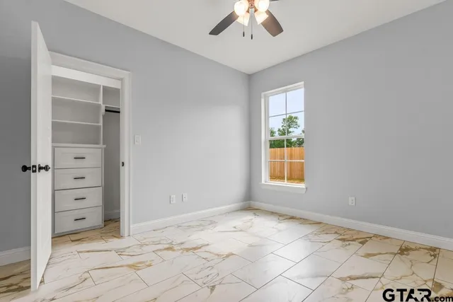 a bathroom with a double vanity sink a toilet and a bathtub