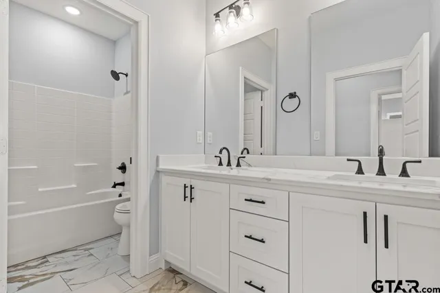 a bathroom with a toilet and a bathtub