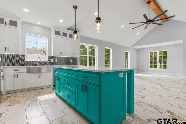 a kitchen with a sink window and cabinets