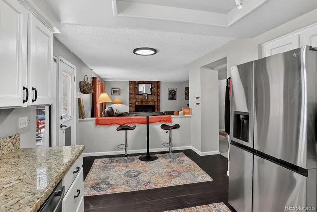 a kitchen with stainless steel appliances granite countertop a refrigerator and a stove