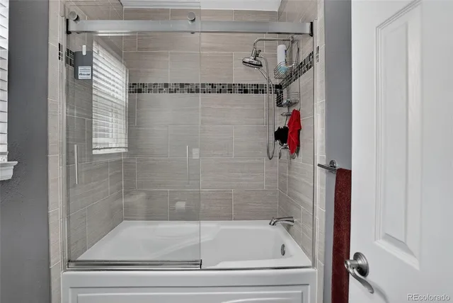 a bathroom with a bathtub and shower