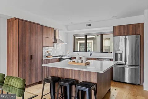 a kitchen with granite countertop a stove and a refrigerator