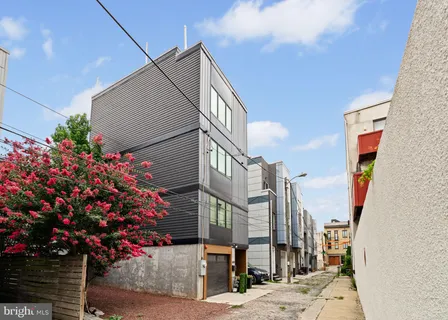 a front view of a multi story residential apartment building with yard