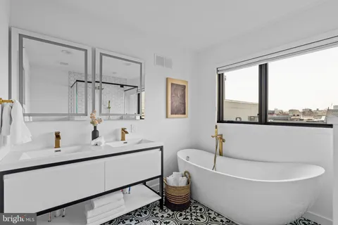 a bathroom with a sink toilet and mirror