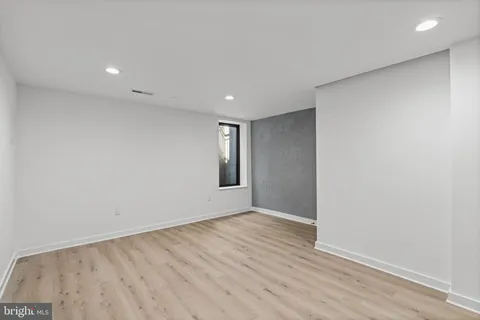 a view of a livingroom with wooden floor and a window