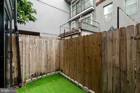a view of a house with a wooden fence