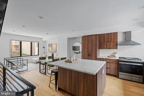 a kitchen with stainless steel appliances a sink stove and cabinets
