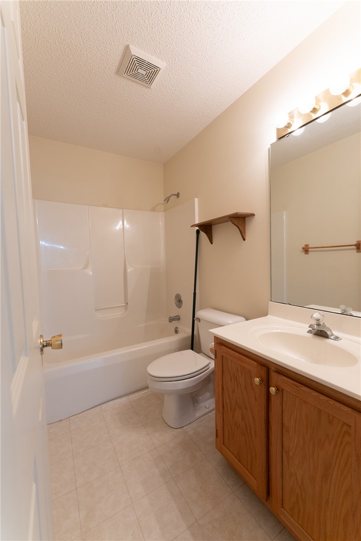 102 Roderick Drive Seneca, SC 29678 - Photo 16 of 23 This bright bathroom features a vanity, mirror, toilet, and bathtub with a shower.