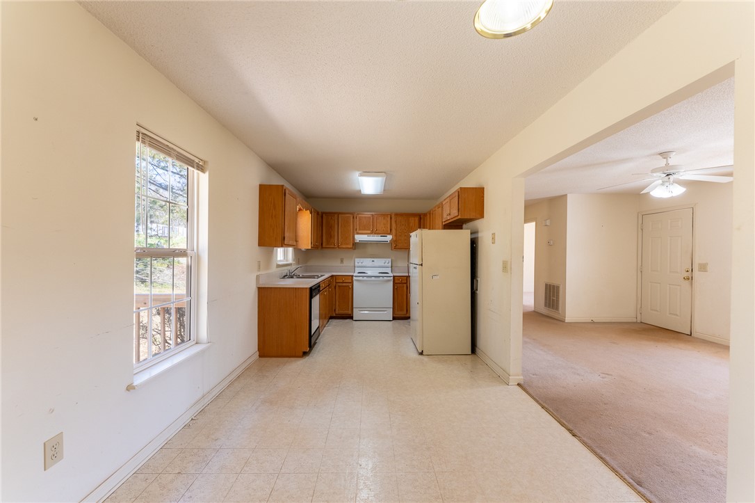 102 Roderick Drive Seneca, SC 29678 - Photo 9 of 23 This spacious kitchen offers functional appliances and ample cabinet space, flowing seamlessly into an inviting living area.