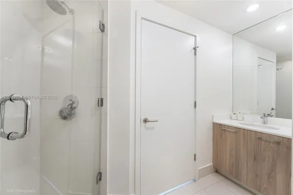 a bathroom with a shower and a sink