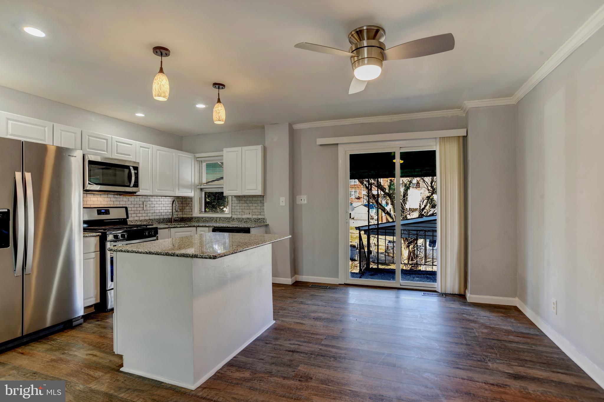 4240 Flowerton Road Baltimore, MD 21229 - Photo 7 of 28 Kitchen with island and stainless steel appliances