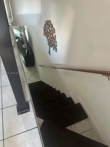 a bedroom with a bed and a ceiling fan