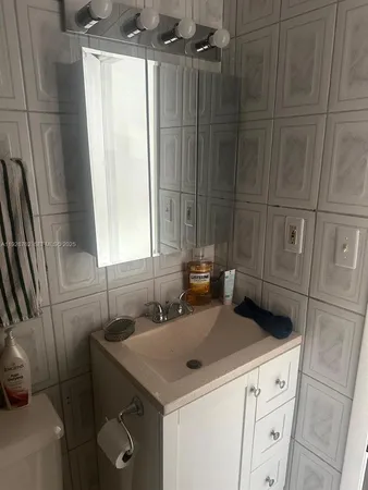 a bedroom with two beds and a window