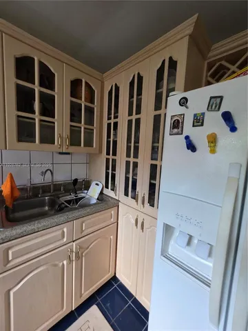 a white toilet sitting next to a white cabinet