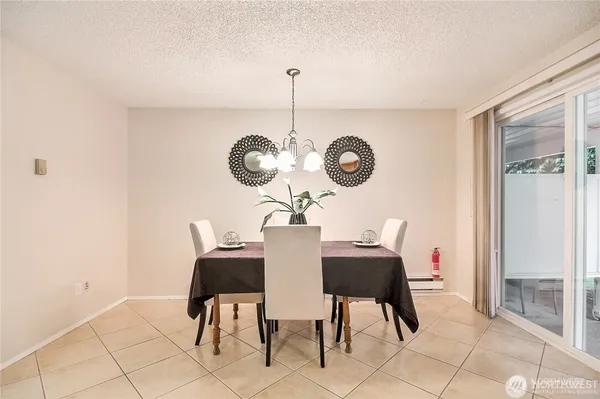 a view of a dining room that has a table and chairs in it