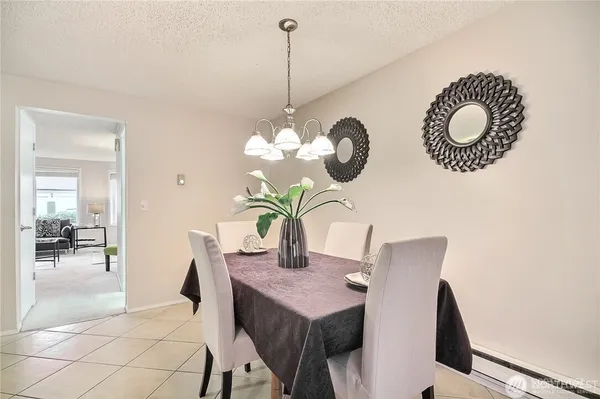 a view of a dining room with a table and chairs