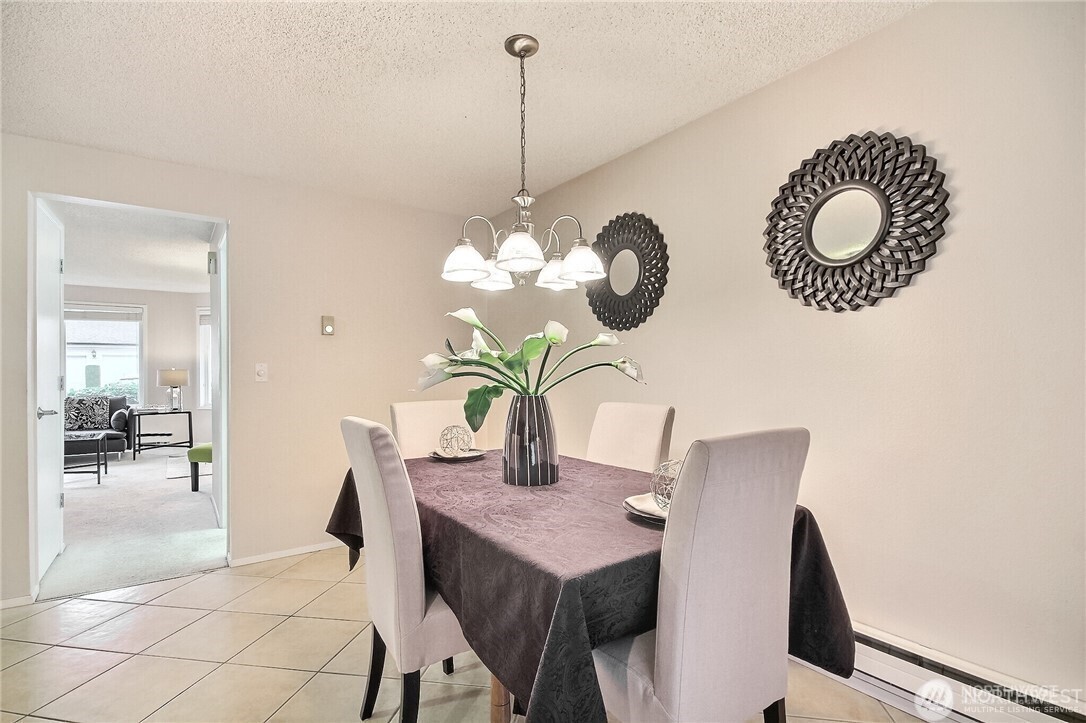 4514 Southwest 319th Place, Unit D Federal Way, WA 98023 - Photo 13 of 21 a view of a dining room with a table and chairs