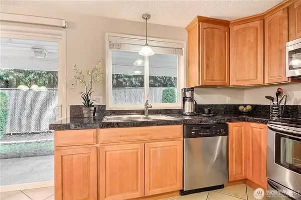 a kitchen with stainless steel appliances granite countertop a stove a sink and a granite counter tops