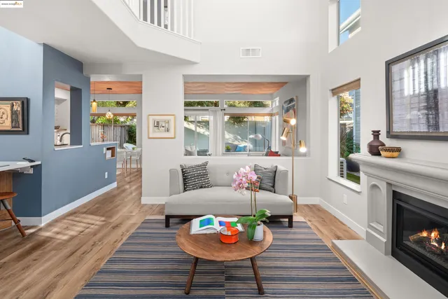 a kitchen with stainless steel appliances a sink dishwasher a refrigerator and a stove with wooden floor