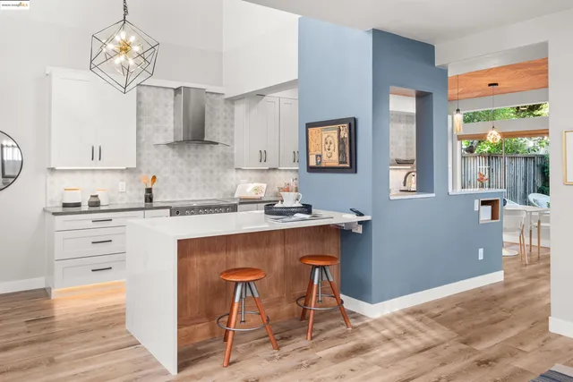 a kitchen with a sink a counter space and cabinets