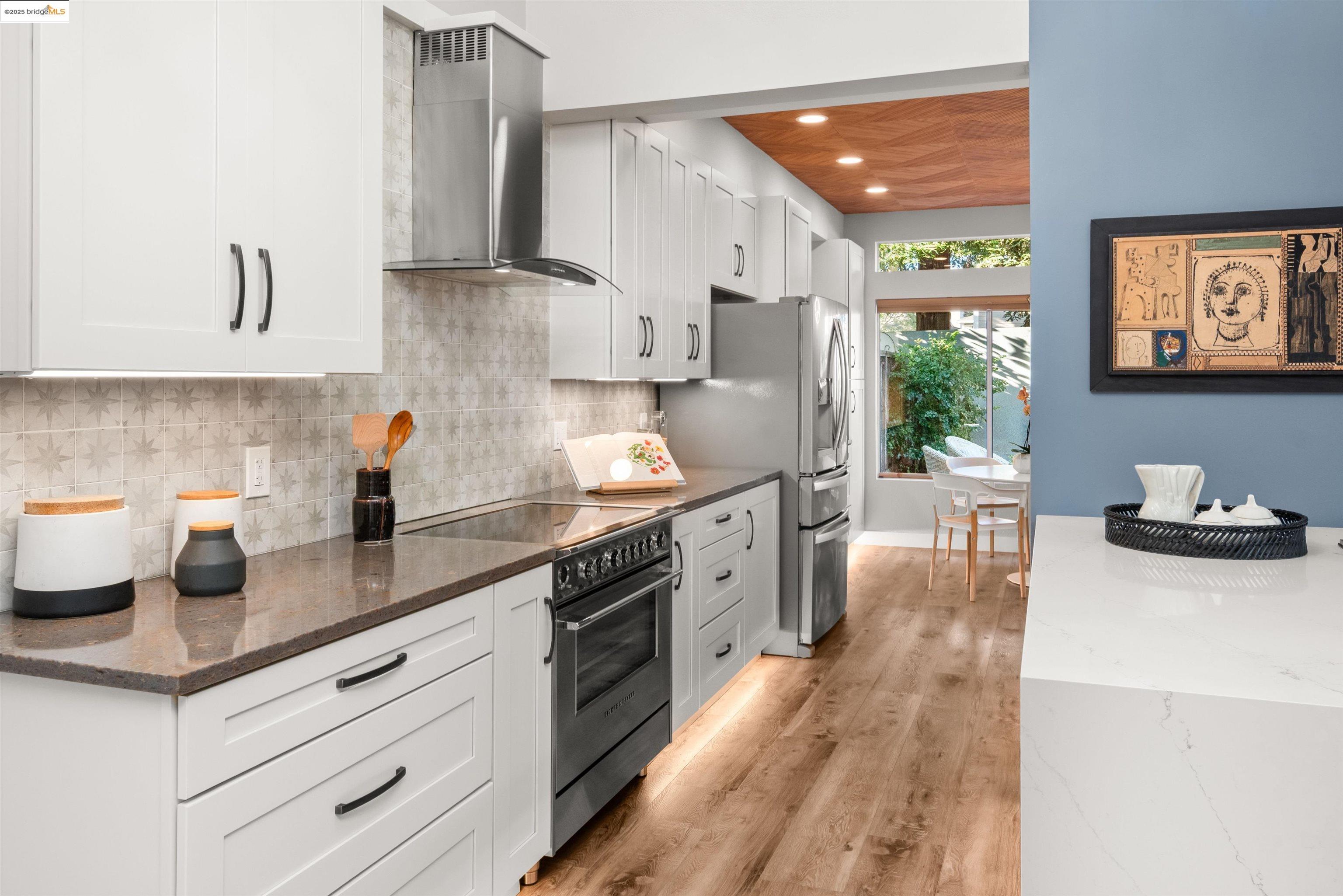 35 Southwind Circle Richmond, CA 94804 - Photo 15 of 59 a kitchen with stainless steel appliances a sink dishwasher a refrigerator and a stove with wooden floor