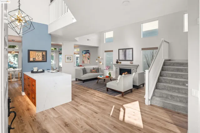 a large living room with furniture a fireplace and a large mirror