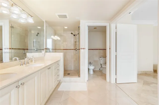 a bedroom with a bed and a flat tv screen on wall